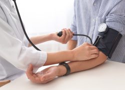 Doctor taking a patient's blood pressure